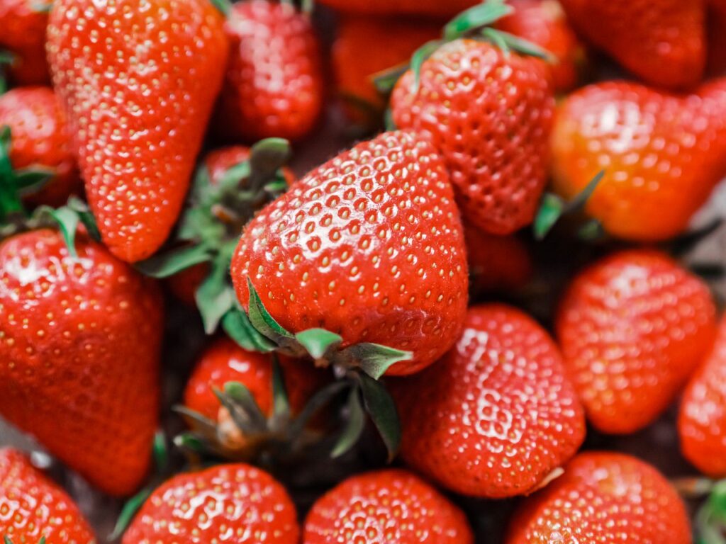 Vivid close-up of fresh red strawberries showcasing rich texture and vibrant colors.